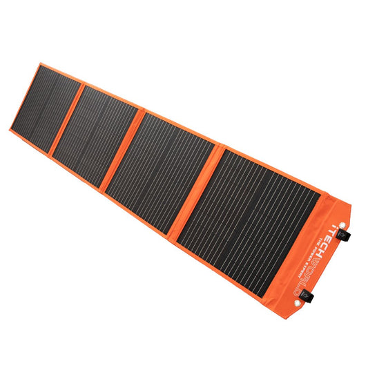 A folded portable solar blanket with black solar cells and orange edges, designed for outdoor use.